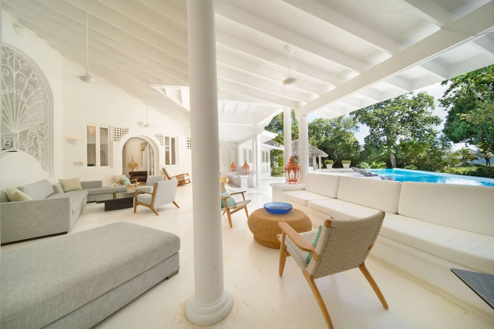 Covered lounge with pool view under a white beamed roof, Cacique 26, Cacique, Casa de Campo®