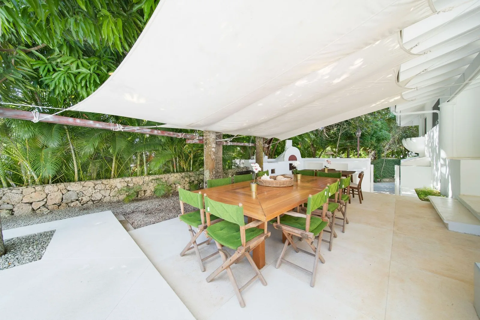 Outdoor dining table under a shade sail, Cacique 26, Cacique, Casa de Campo®