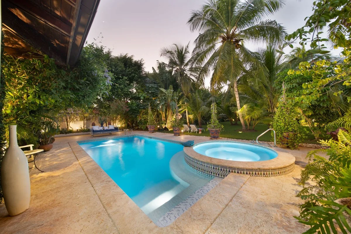 Pool and jacuzzi lit at dusk among palm trees, Rancho Arriba 30, Rancho Arriba, Casa de Campo®