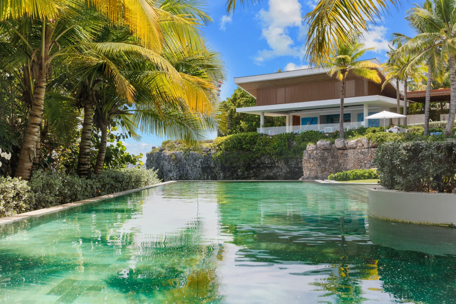 Pool surrounded by tropical gardens below the villa, Villa Farallón, Punta Aguila, Casa de Campo®