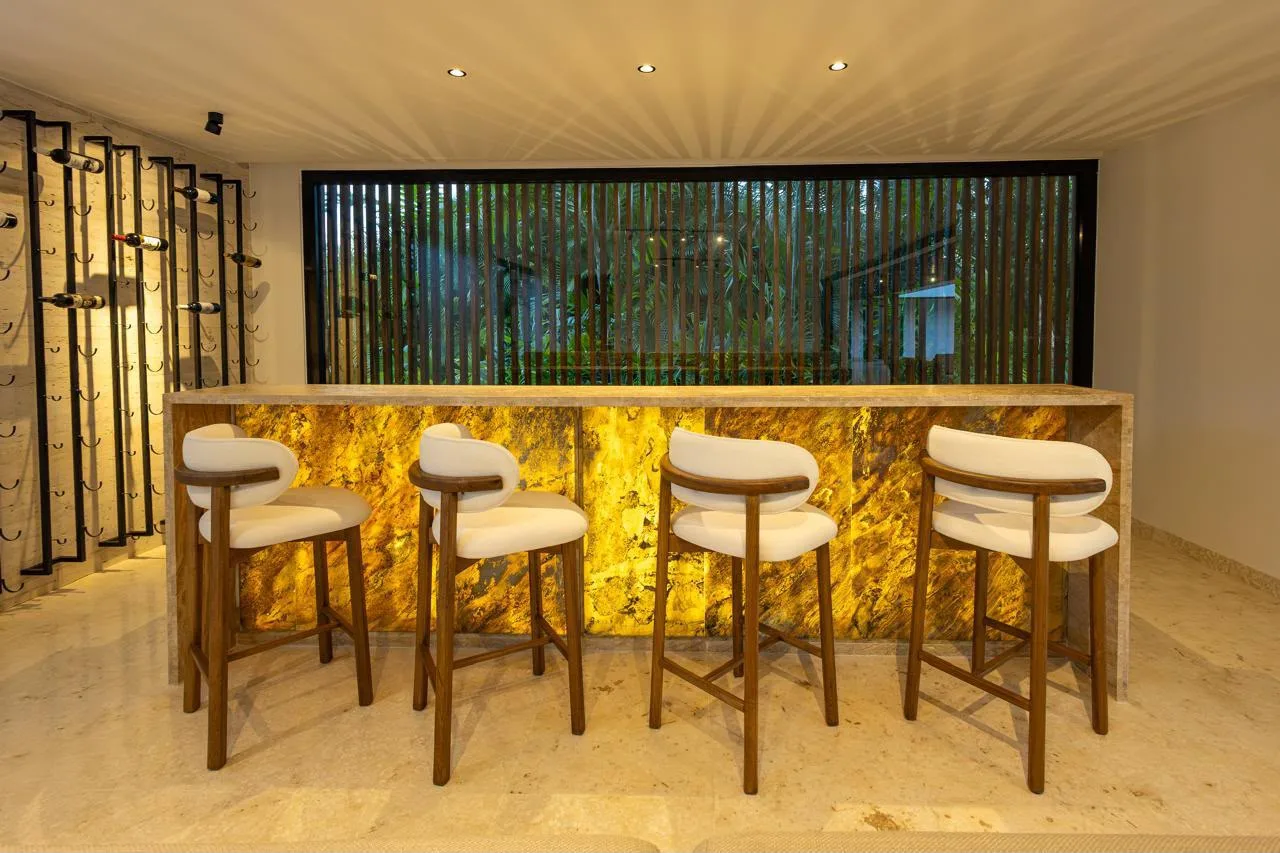 Bar with backlit stone wall and stools, Barranca Este 14, Barranca Este, Casa de Campo®